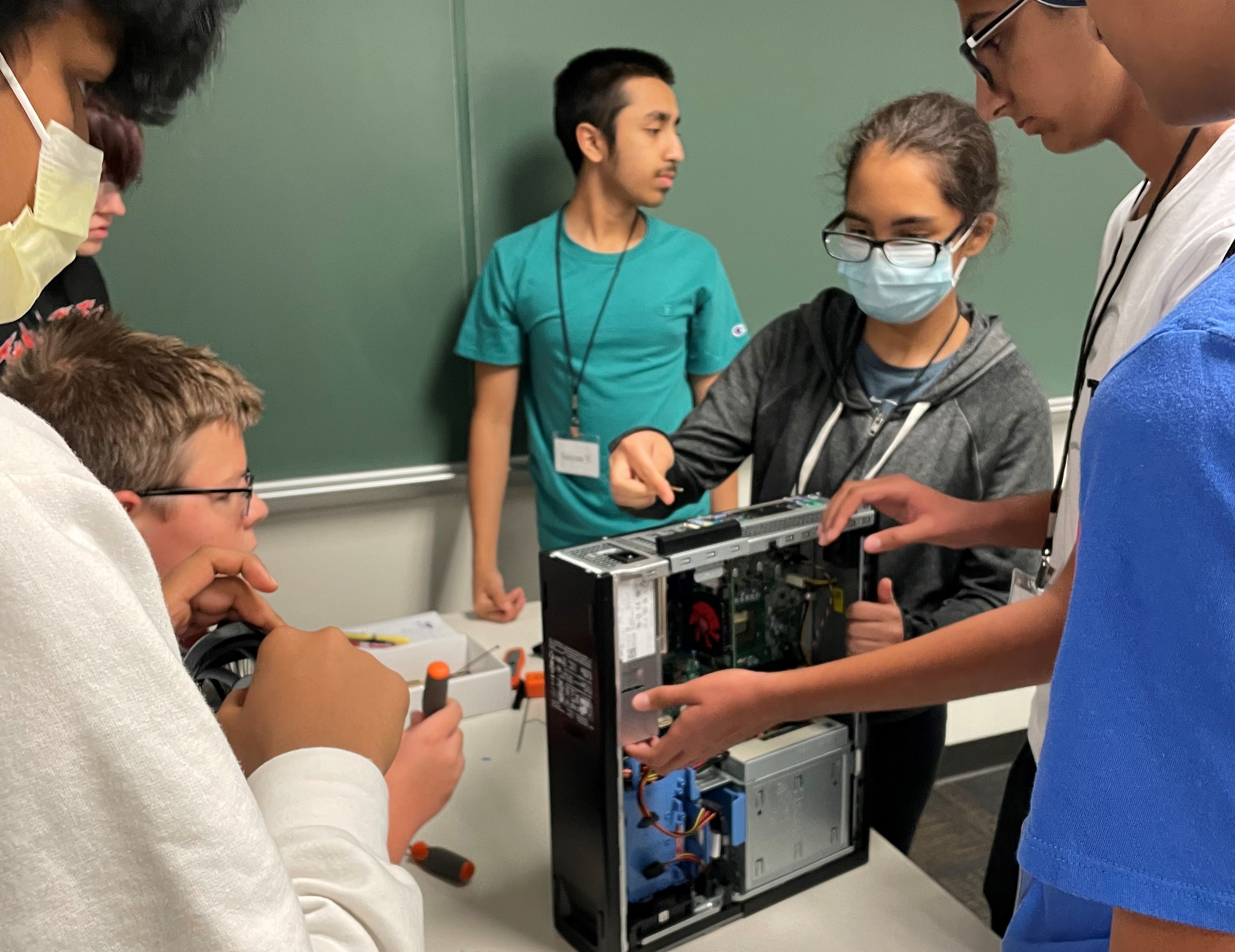 Students examine computer hardware.